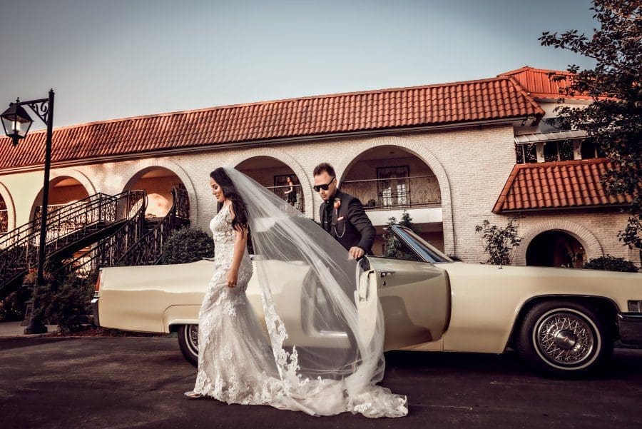 bride wedding ceremony veil white wedding dress vintage car outside windy sunny